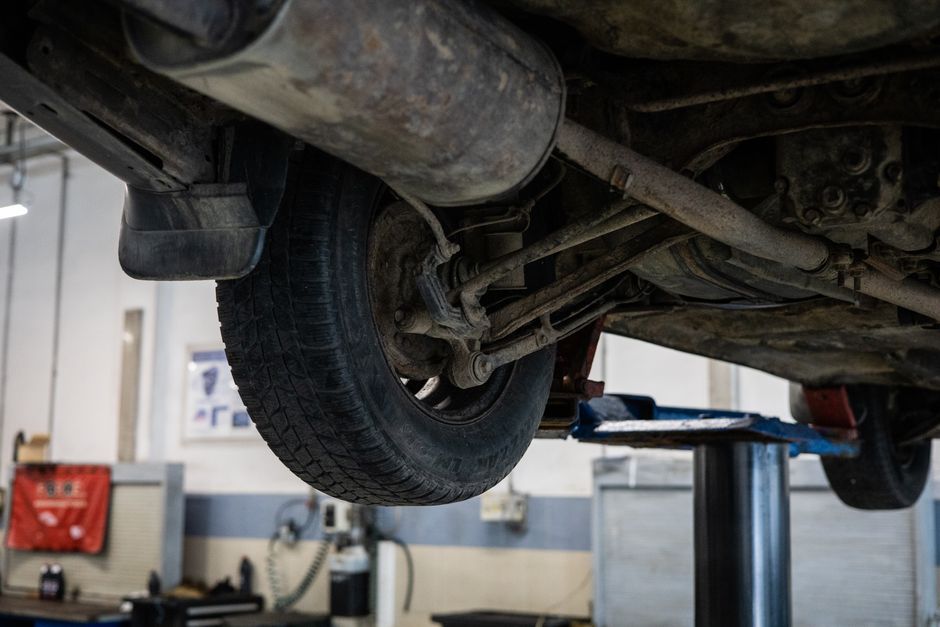 Technician performing precision tire installation on a vehicle