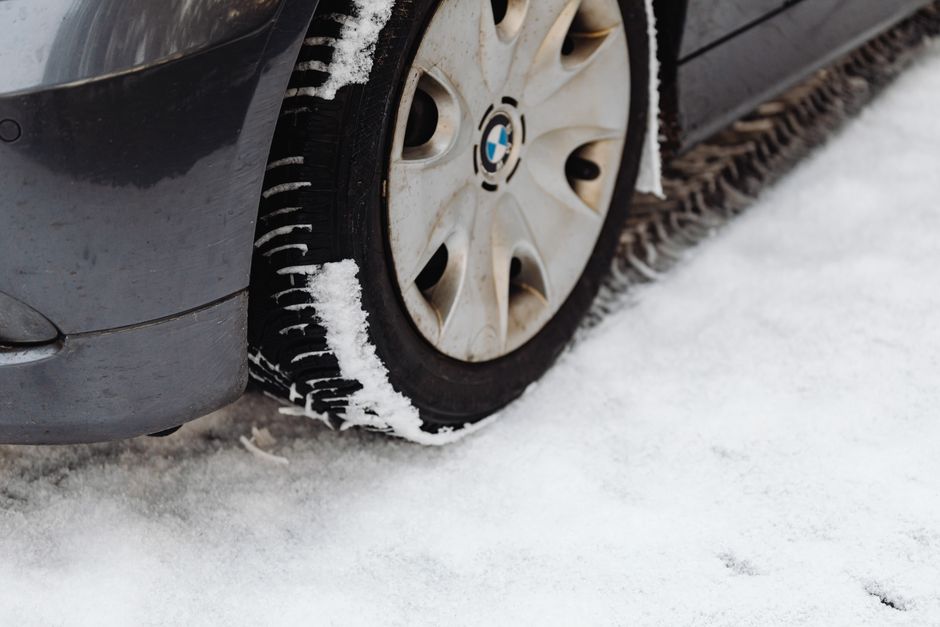 Mechanic checking tire tread depth during a tire rotation