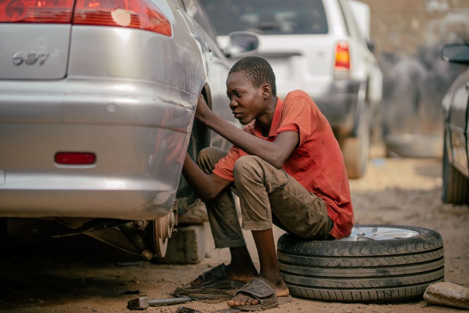 Mechanic changing a car tire in a professional garage